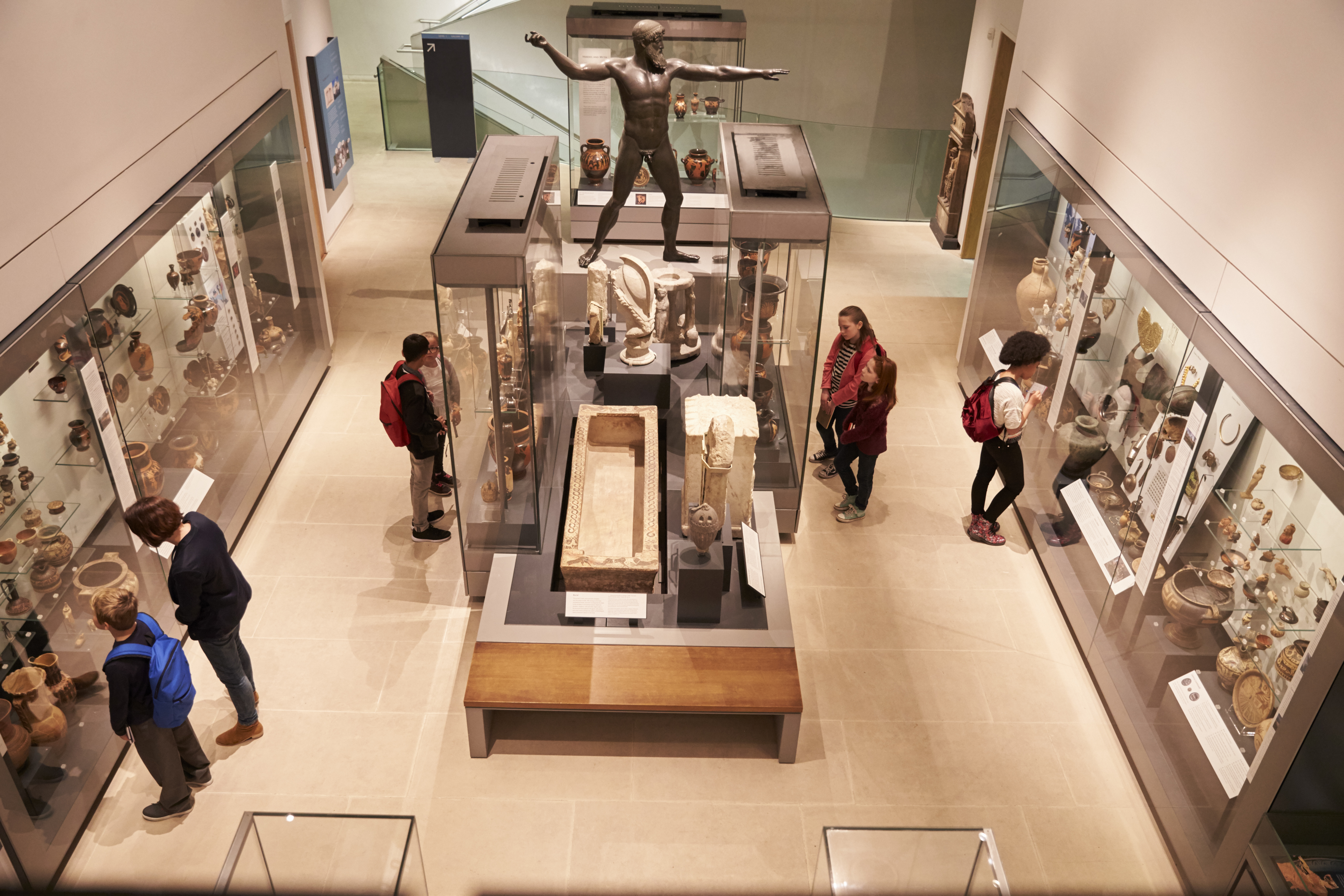 Visitors exploring exhibits inside a museum gallery